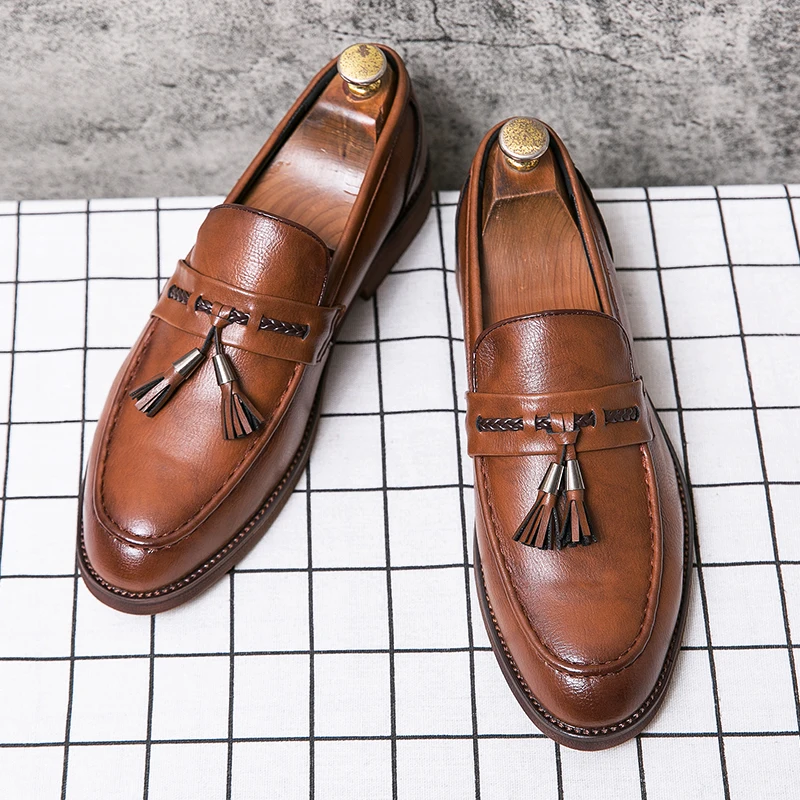 Loafers in Leather with pompons