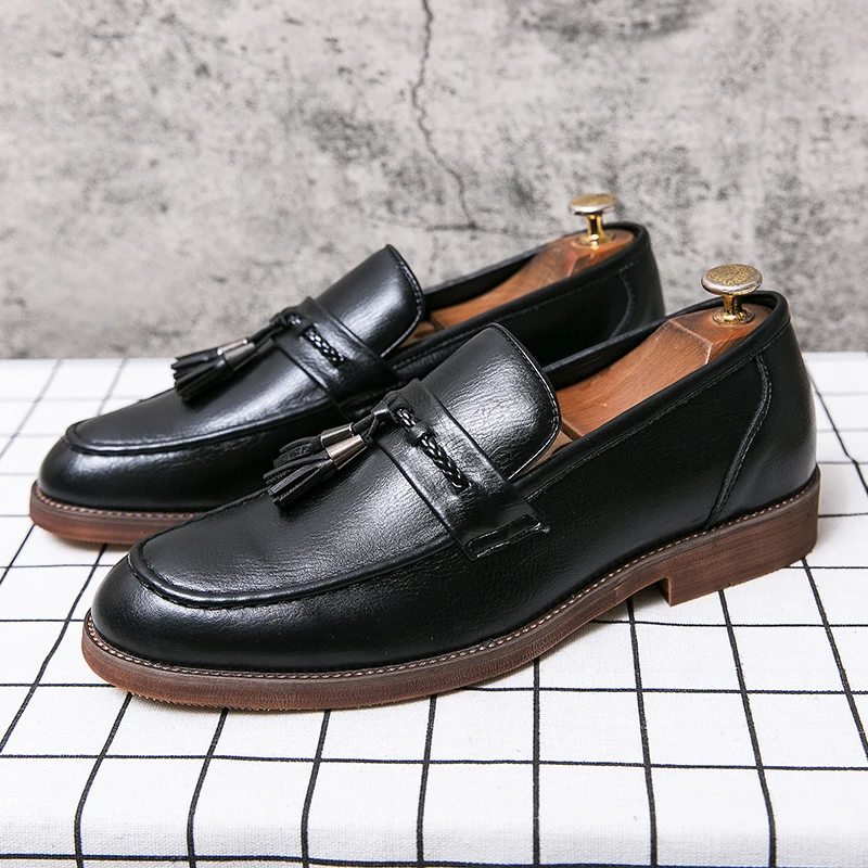 Loafers in Leather with pompons
